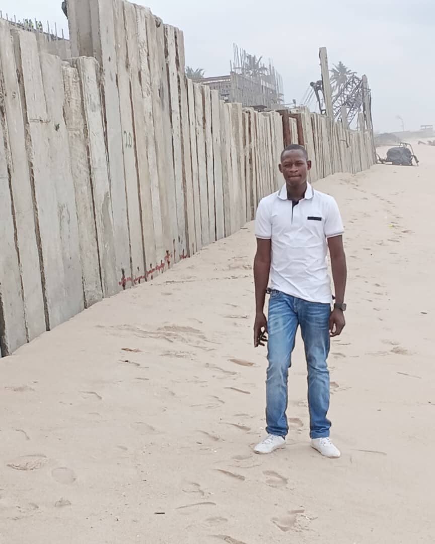 A team of construction workers and engineers collaborating on a blueprint at a construction site.